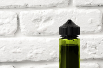 Refill liquid for electronic cigarettes against brick wall background