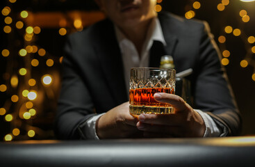 Closeup businessmen holding a glass of whiskey