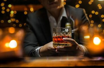 Closeup businessmen holding a glass of whiskey