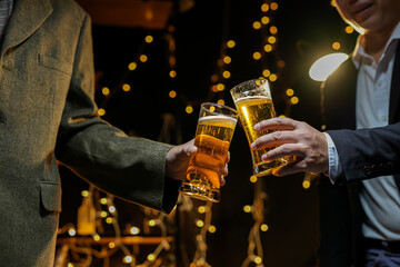 food and drink male friends are happy drinking beer and clinking glasses at a bar or pub.