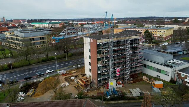 Aerial drone rotating shot over an empty under construction building site in Brunswick, Germany during evening time.