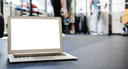 Netbook mock up with white screen placed on floor in gym