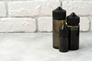 Refill liquid for electronic cigarettes against brick wall background