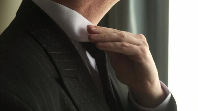 Business man put suit on during morning routine at home, preparing to go to work - Powered by Adobe