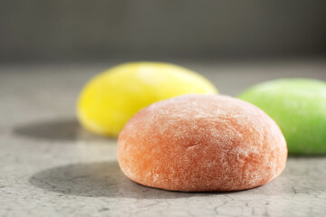 Mochi ice cream with different flavors on gray background.