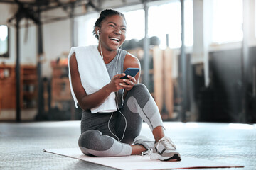 Phone, earphones and funny black woman in gym for fitness, sports or exercise. Smartphone, music...