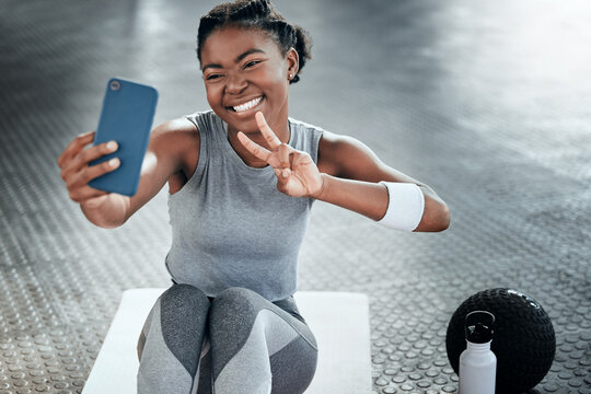 Black woman, gym selfie and peace with smile on floor for fitness, workout and wellness on social media app. Influencer girl, photography and blog for exercise, icon and health for lifestyle in club
