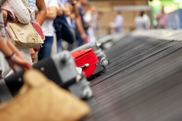 Baggage claim luggage conveyor belt with suitcase at airport - 609860602