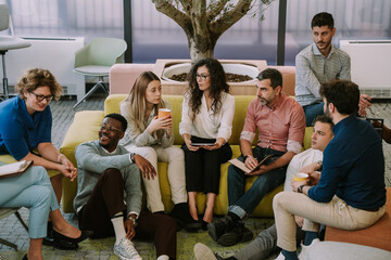 Diverse employees having a conversation in a modern co working space