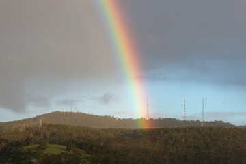 rainbow setting over the hills in australia