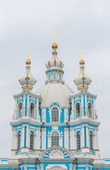 Fototapeta na wymiar Very blue Smolny Cathedral in St. Petersburg, Russia, on a cloudy summer day. 