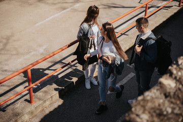 Three friends talking and walking