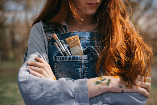 Close up of girl with brushes in her pocket
