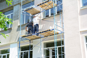 Painting house walls. Builder contractors repair and painting external house walls . House...