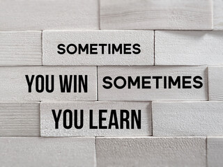 Inspirational and Motivational Concept - 'sometimes you win sometimes you learn' text on wooden...