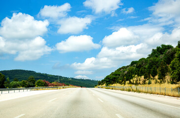 Empty Highway in the mountains with blue sky and white clouds, travel transport beauty in nature...