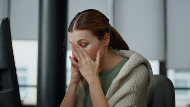 It manager rubbing eyes at workplace closeup. Exhausted woman employee overwork