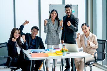 Group of Asian business man and woman express confidence and happiness also look at camera after success the project.