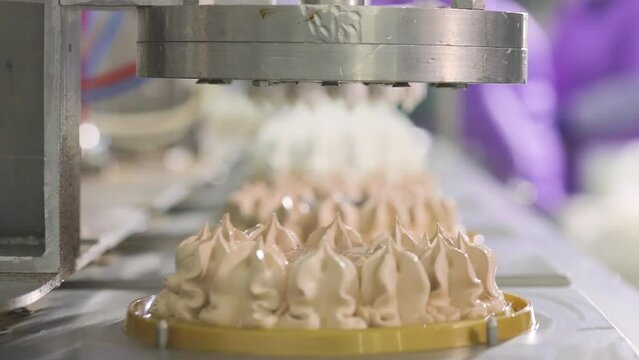 Cakes on a conveyor belt. Large automated production of cakes. Making an ice cream cake. Food production