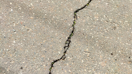 Obraz premium Abstract grey background and asphalt texture with a black curved crack. Pattern and frame. The concept of separation, destruction, breakage, collapse