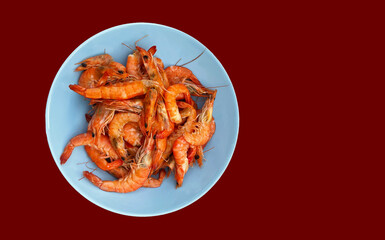 Shrimp on a blue plate. Seafood. Clams.