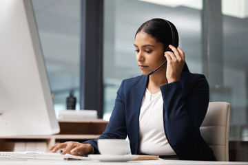 Computer, telemarketing and woman typing in call center office for customer service, help desk or technical support. Crm, contact us and female sales agent, business consultant or employee listening.