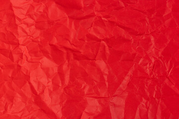 Red crumpled paper texture background.
