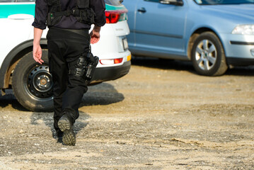 Slovak cop dressed in black with a gun pinned to his leg.   Policeman in Liptovsky Mikulas,...