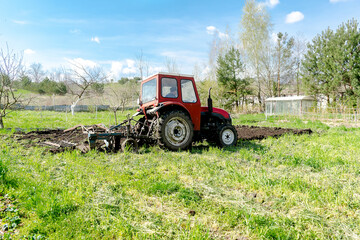 Tractor machinery plowing agricultural field meadow at farm at spring autumn.Farmer cultivating make soil tillage before seeding plants crops, nature countryside rural scene