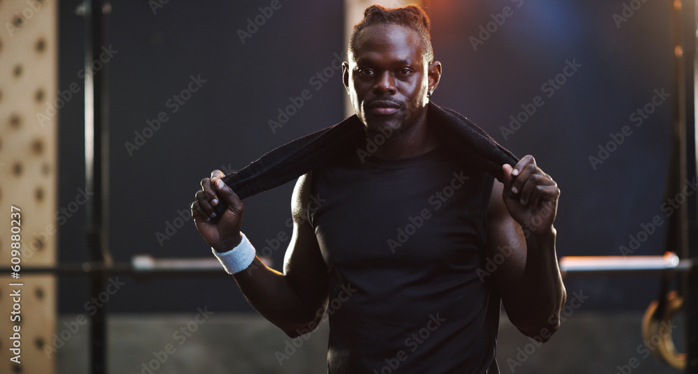 Poster Serious, bodybuilder and portrait of black man in gym for training, exercise and strong workout. Fitness, muscles and face of male person with sweat towel for challenge, wellness and body strength