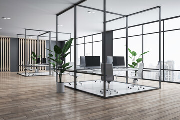 Perspective view on stylish workspace tables with modern computers in dark metal frame on wooden floor in sunlit coworking office with dark wall background and city view from big window. 3D rendering