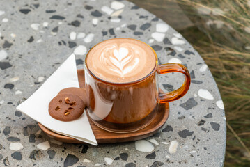 Cup of cappuccino with latte art with two chocolate biscuit high angle view - 609884450