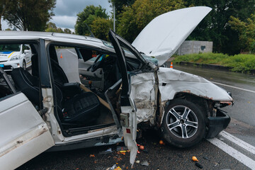 A car accident involving two cars on a city street. Damaged cars. Severe accident. Close-up.