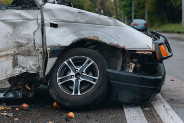 A car accident involving two cars on a city street. Damaged cars. Severe accident. Close-up.