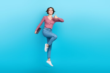 Full body portrait of pretty carefree lady arm hold netbook demonstrate thumb up jumping isolated on blue color background