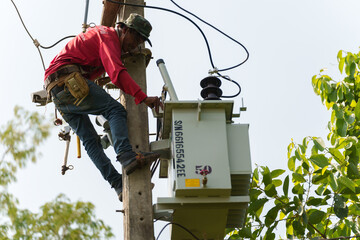 worker install a three-phase current transformer on the electric pole