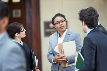 Lawyers talking outside courtroom