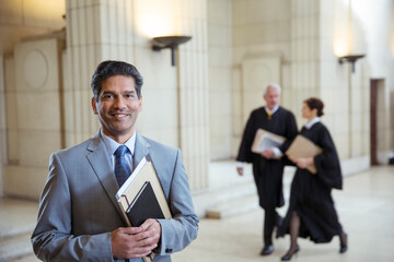 Lawyer holding legal documents in courthouse