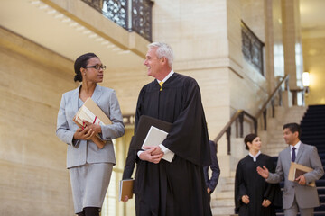 Judge and lawyer walking through courthouse together