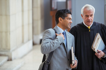 Judge and lawyer talking in courthouse