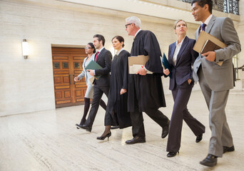 Judges and lawyers walking through courthouse together