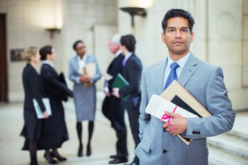 Lawyer holding legal documents in courthouse