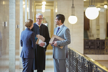 Judge and lawyers talking in courthouse