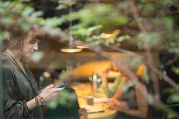 Businesswoman using cell phone in office