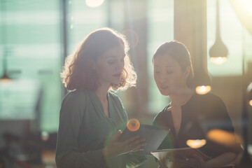 Businesswomen using digital tablet in office