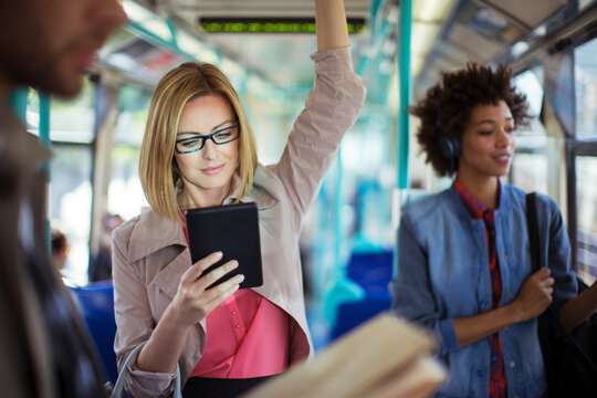 Businesswoman using digital tablet on train