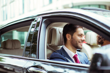 Businessman smiling in car