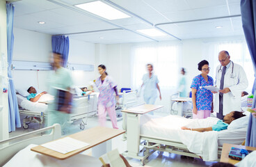 Doctors and nurses making rounds in hospital room