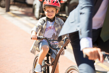 Portrait smiling boy riding bicycle on sunny road