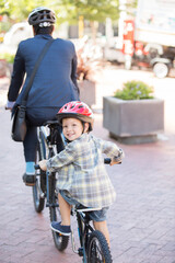 Portrait smiling boy riding tandem bicycle with businessman father